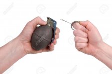 2623358-Hand-grenade-in-a-woman-s-hand-with-the-pin-pulled-isolated-over-a-white-background-Stoc.jpg
