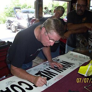Ron's turn to sign.