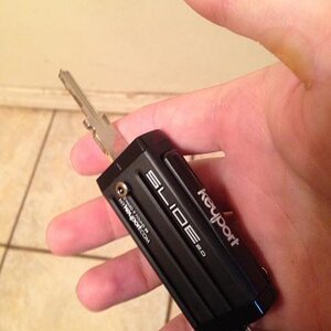 https://mykeyport.com
Holds ignition key, saddle bag key, 2house keys ,& flashlight, thumb drive too
Perfect for me. 
Fyi only 2013& earlier transpond