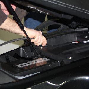 Putting air pressure in rear suspension, to lift it up for roll off of base.