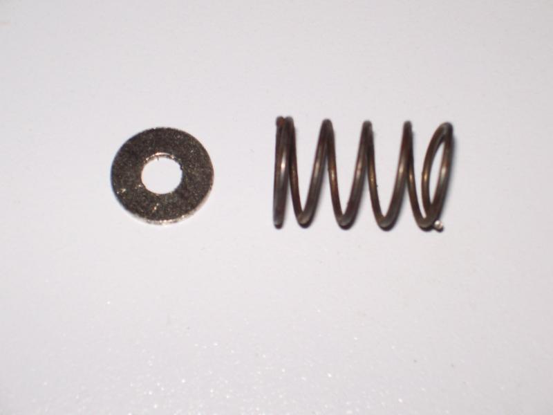 A 1/2" diameter washer and a spring. Glue or braze the washer to the spring and insert it under the catch in the hood release.