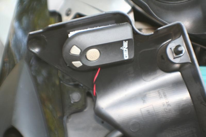 Garage Door opener mounted under computer and fuse cover.